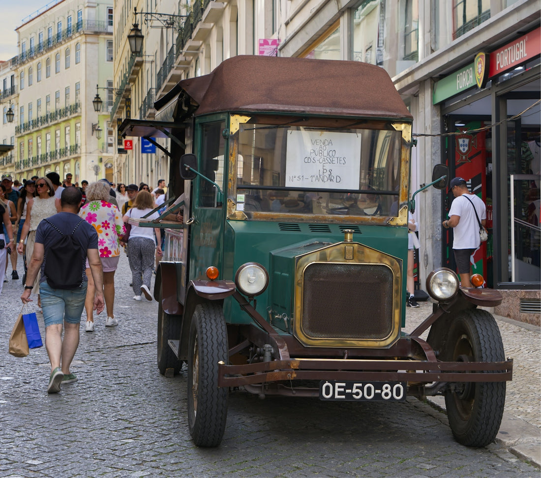 An old, vintage truck is parked on the street.