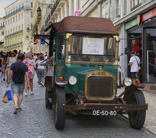 An old, vintage truck is parked on the street.