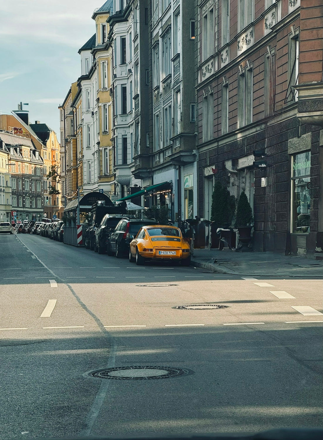 Yellow sports car parked on a european street.