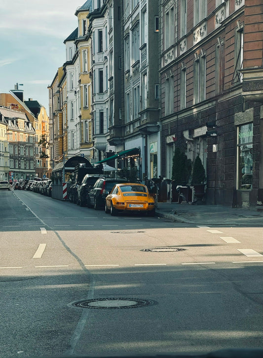 Yellow sports car parked on a european street.
